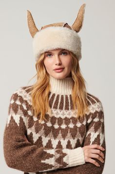 Don the charismatic Viking hat and become the life of winter's party, whether you're in the valley or speeding down the slopes. Featuring a pair of sheepskin horns—lending levity to arctic weather—the vintage-inspired Viking boasts a dual-color suede exterior. And you just can't beat its plush shearling interior-side for effortless warmth and all-day comfort. The velvety-soft Viking is finished with a wide but adjustable turned-up shearling brim, charming raw-edge seams, and a dash of good fun. Viking Hat, Novelty Hats, Promo Gifts, Sheepskin Slippers, Sheepskin Coat, Winter Party, Sheepskin Rug, Hat Making, Raw Edge