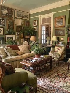 a living room filled with lots of furniture and pictures on the wall above it's windows