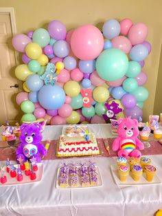 a birthday party with balloons, cake and decorations