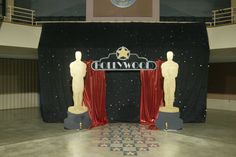 the stage is decorated with red curtains and statues