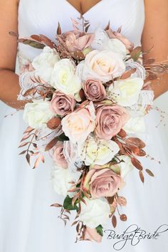 a bridal holding a bouquet of pink and white flowers