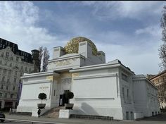 a large white building with a gold dome on top