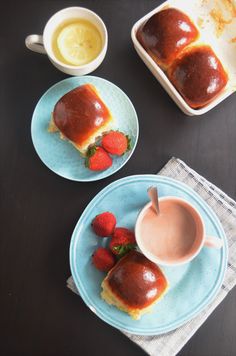 two plates with food on them, one has strawberry jam and the other has strawberries