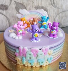 a birthday cake decorated with bears and rainbows