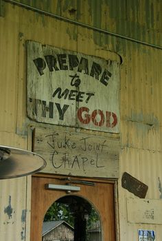 an old sign on the side of a building that says prepare to meet my god