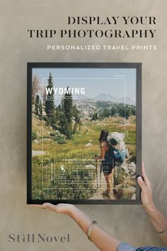 a person holding up a poster with the words wyoming on it