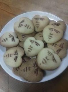 a white plate topped with cookies covered in writing