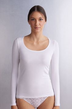 Long sleeve top in soft micro-modal with scoop neckline. Close fit.
The model is 5’ 9” (175 cm) tall and is wearing a size S.

This garment is made of a plant-based fabric derived from sustainable and renewable wood sources. White Seamless Tops With Scoop Back, White Seamless Scoop Back Top, White Seamless Top With Scoop Back, Undershirt Tank Top, High Waisted Briefs, Seductive Clothes, Scoop Neck Top, Photography Women, Knitwear Women