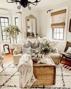 a living room filled with lots of furniture and decor on top of a white rug