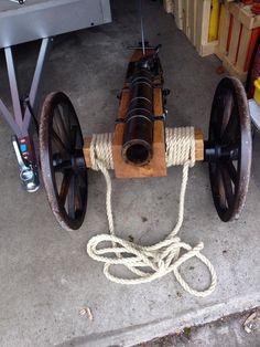 an old fashioned wooden cart with rope on it