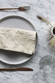 a white plate topped with a napkin and fork