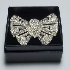 Vintage Rhodium Plated Clear Pave Rhinestone Bow Pin. Radiant Faceted Round Rhinestones Adorn This Beautiful, Unique Piece. The Bow Design Features Delicate Cutouts And Ruffled Edges. This Is A Stunning Pin That Looks Like Real Diamonds! My Mother Worked At G's Jewelry For Over 20 Years And Amassed A Nice Collection Of High Quality Costume Jewelry. This Piece Was Never Worn And Is In Mint Condition. **Box Only For Display** Diamond White Rhinestone Jewelry For Formal Occasions, Formal Silver Jeweled Jewelry, Elegant Silver Rhinestone Jewelry, Elegant Silver Jewelry With Rhinestones, Elegant Rhinestone Jewelry For Anniversary, Glamorous Bling Jewelry For Anniversary, Classic Jewelry With Bling For Formal Occasions, Formal Crystal Jewelry With Bling, Classic Bling Jewelry For Formal Occasions