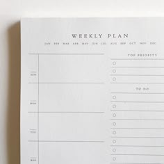 the weekly plan is displayed on top of a piece of white paper with black writing