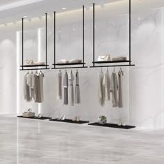 an empty clothing store with clothes hanging on the racks and shoes in the foreground