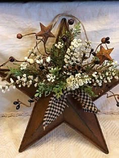 a wooden star with flowers and berries on it