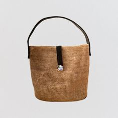 This raffia handbag is the perfect summer companion. Made from natural raffia fibers, it is lightweight, durable and environmentally friendly. Its light tea color easily matches all summer outfits. The bag is hand-woven, which gives it a unique artisanal appearance. It has two leather handles, which are long enough to be carried on the shoulder or in the hand. ▫️ NATURAL MATERIAL ▫️ HANDMADE ▫️ ECO-FRIENDLY Casual Jute Straw Bag With Bamboo Handle, Spring Jute Straw Bag With Leather Handles, Eco-friendly Woven Beige Straw Bag, Chic Natural Straw Beach Bag, Casual Light Brown Woven Straw Bag, Eco-friendly Spring Bucket Bag With Natural Fiber, Spring Eco-friendly Bucket Bag With Natural Fiber, Eco-friendly Spring Bucket Bag, Chic Natural Color Bucket Shoulder Bag