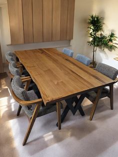 a large wooden table with six chairs around it