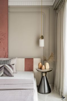 a white bed sitting in a bedroom next to a window