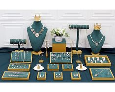 a table topped with green and gold jewelry