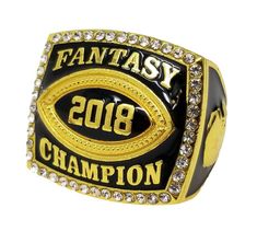 a gold and black ring with the words fantasy champion on it's side, in front of a white background