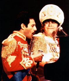 a man and woman dressed in costumes on stage