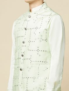 This Mint Green Kurta Bundi Jacket Set will instantly give an elegant look. This 3 piece kurta bundi set features a mint green mirror embroidered bundi jacket with a mint green kurta, front button placket, and a mandarin collar. It is paired with white churidar pants. An ideal outfit for traditional occasions, and special events.

Size Chart For Men





	
	
					Men's Size Chart
		

		
		
						
				Size Chart For Men
				Custom Size Measurement Guide
			
			
				
				
				Custom Size Measureme Designer Sherwani For Spring, Fitted Cotton Nehru Jacket With Gota Work, Spring Festive Bandhgala With Gota Work, Traditional Bandhgala With Gota Work For Spring, Traditional Spring Bandhgala With Gota Work, Spring Pista Green Kurta With Mirror Work, Spring Cotton Nehru Jacket With Zari Work, Straight Kurta Nehru Jacket With Zari Work For Spring, Spring Nehru Jacket With Zari Work, Straight Kurta Style