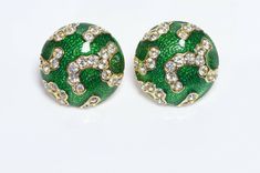 Oscar de la Renta green enamel and crystal earrings in excellent condition. Approximate Measurements: Diameter 0.9” Made in USA. Formal Green Enamel Jewelry, Green Jeweled Round Earrings, Green Metal Clip-on Earrings For Gift, Green Jeweled Earrings For Formal Occasions, Green Metal Clip-on Earrings, Green Enamel Clip-on Earrings, Green Enamel Clip-on Jewelry, Green Enamel Clip-on Earrings As Gift, Green Clip-on Metal Earrings