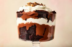 a dessert in a glass is topped with whipped cream and chocolate