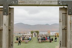 an outdoor ceremony with people sitting on benches