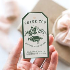 a person holding up a thank you tag