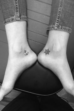 two people with anchor and star tattoos on their feet