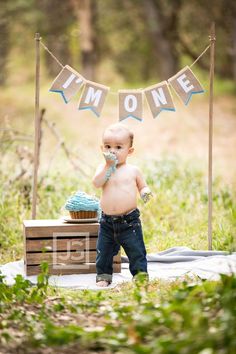 a baby standing in front of a cake with the words i'm home on it