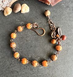 Gorgeous fall BRACELET made with 8mm red-orange Imperial Jasper beads. In one end of the bracelet there is a hand-forged small hook, antiqued, and sealed to protect the finish. In the other end an extender (chain) with wire-wrapped Jasper beads and a copper plated leaf. This bracelet is size S/M, fits 6.5" to 8" wrists (with the extender). I can add beads and make it a little bigger (at no extra cost). Please measure your wrist with a flexible tape, and leave your size in NOTES at CHECKOUT. EXTRA SMALL: 5.5" to 6.5" SMALL: 6.5" to 7.5"    MEDIUM:  7.5" to 8.5" LARGE: 8.5" to 9.5"  **To make this bracelet I used natural gemstones. They have characteristics and color variations that make them unique and beautiful** PHOTOS: I take all the pictures with natural light, doing my best to accurate Fall Bead Jewelry, Adjustable Orange Bracelets With 8mm Beads, Handmade Orange Spiritual Bracelets, Spiritual Hand Wrapped Orange Jewelry, Adjustable Round Orange Jewelry, Adjustable Red Nature-inspired Jewelry, Orange Beaded Jewelry, Brown Bracelet With Lobster Clasp As Gift, Orange Round Beads Bracelets As Gift