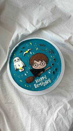 a birthday cake with an image of a boy and a ghost on the side, sitting on top of a white sheet