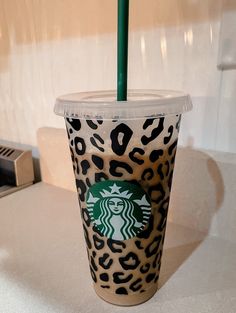 a starbucks cup with a green straw in it