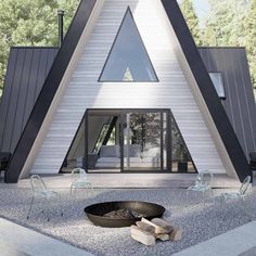 a house that is shaped like a triangle and has a fire pit in the front