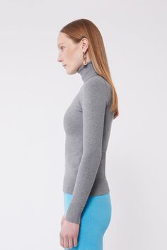 Everyone's staple: a flattering, fitted soft turtleneck. Our signature peachskin classics are instant wardrobe staples. They stand out for their softness, simplicity, and comfort. Not only are they stretchy and perfectly form-fitting, but they also have slight compression properties that feel and look like shape wear. With their carved waist they won't bunch, web, or ride up. The dense and compact peachskin fabrication allows the wearer to go bra-less or layer any color underneath without showin Gray Fitted Turtleneck For Fall, Fitted Gray Turtleneck For Fall, Fitted Gray Turtleneck For Winter, Versatile Solid Fitted Turtleneck, Classic Stretch Fine Knit Turtleneck, Solid Fitted Versatile Turtleneck, Fitted Solid Color Versatile Turtleneck, Versatile Fitted Turtleneck, Fitted Fine Knit Solid Color Turtleneck