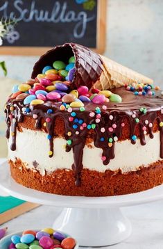 a cake with chocolate frosting and sprinkles sitting on top of a table