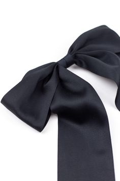 The Oversized Bailee Matte Satin Bow brings the drama! This statement bow is the perfect finishing touch for your holiday soirees but also flawlessly completes a jeans and tee look!! This bow is secured on a 3" barrette. Approximate bow measurements: 9.5”W x 12”L *Please note these bows are handcrafted and therefore vary slightly in size and look. Measurements are approximate. **Any props seen in photo are not available for sale. The Bailee bow is sold individually regardless if it is shown in p Chic Decorative Bow For Black Tie Events, Classic Black Ribbon Bow For Evening, Classic Evening Bow With Black Ribbon, Formal Black Ribbon Bow, Classic Bow With Bow Tie Back For Party, Chic Detachable Bow Tie For Black Tie Events, Chic Evening Bow With Detachable Feature, Chic Evening Bow Tie With Satin, Classic Party Bow With Tie Back