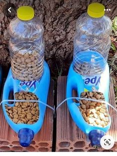 two plastic water bottles filled with dog food