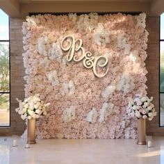 the wall is covered with flowers and monogrammed initials