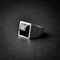 Embrace your bold side with my handmade square onyx sterling silver signet ring. This statement ring features a striking black onyx, exuding goth vibes and timeless allure. As a versatile onyx ring, it will surely captivate and enhance any outfit. Make a powerful impression with this unique signet ring. Each ring is cleaned and polished with care. The weight of the ring may vary according to size. Top measurements: Width - 14.3mm | Height - 14.5mm Approx weight: 9.74gr The ring is set with one l Modern Onyx Signet Ring For Gift, Modern Onyx Signet Ring Gift, Modern Black Sterling Silver Signet Ring, Modern Black Jewelry With Rectangular Stone, Modern Black Ring With Rectangular Stone, Modernist Black Signet Ring With Polished Finish, Black Sterling Silver Rectangular Signet Ring, Modern Black Open Signet Ring, Classic Black Square Jewelry