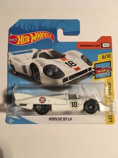 a hot wheels white race car with black numbers on it's front and side