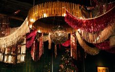 a large chandelier hanging from the ceiling in a room filled with christmas decorations