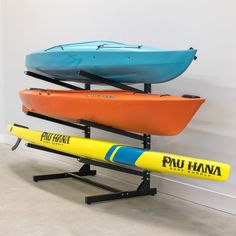 two kayaks are sitting on the wall next to each other