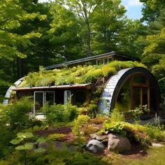 an unusual house with plants growing on the roof and side walls is surrounded by greenery