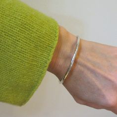 "This handmade heirloom quality sterling silver bangle is such a classic! Made from 3.2mm wide solid round sterling silver, it has such a pleasing weight. It is hand-formed and forged by me... the silver then gets hammered, hammered and hammered some more, creating a surface fully covered in tiny facets that provide a perfectly understated sparkle. The silver has been lovingly sanded and given a polished finish. Available in smooth (unhammered) finish as well, as can be seen in the last two pics Sterling Silver Bangle Bracelet With Shiny Finish, Sterling Silver Bangle With Shiny Finish, Hammered Sterling Silver Bracelet Gift, Gift Polished Sterling Silver Bangle Bracelet, Sterling Silver Bangle With Shiny Finish For Anniversary, Minimalist Sterling Silver Bangle With Shiny Finish, Elegant Hammered Sterling Silver Bracelet Gift, Minimalist Hammered Cuff Bracelet As Gift, Minimalist Hammered Cuff Bracelet Gift