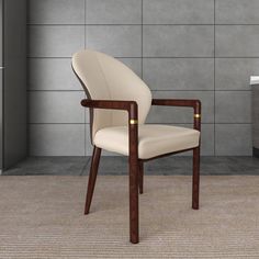 a white chair sitting next to a sink in a room with tile walls and flooring