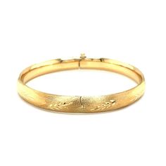 A classic floral carved high polish bangle crafted in 14k yellow gold with a hidden clasp. Bangle Information Width 0.31 inches Clasp Type Hidden Clasp Approximate Weight 9.5 gram(s) - 10.3 gram(s) Available Sizes 7 - 8" Metal 14K Yellow Gold " Luxury Carved Bangle For Women, Luxury Gold Clasp Bangle Jewelry, Luxury Gold Bangle With Gold Clasp, Luxury Carved Bangle For Formal Occasions, Luxury Hallmarked Gold Bangle, Luxury Gold Hallmarked Bangle, Luxury Hallmarked Yellow Gold Bangle, Luxury Yellow Gold Bangle For Festive Occasions, Video Overlay