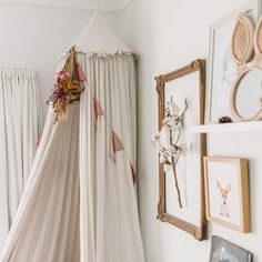 a bed with a white canopy hanging from it's side